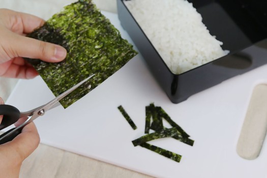 Cutting seaweed into strips for eyes of bento assemble