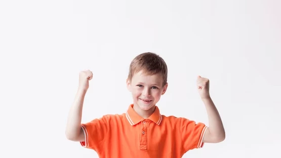 article_Young boy with arms raised