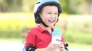 Red shirt kid holding Friso Gold formula milk