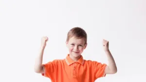 article_Young boy with arms raised