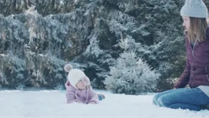 Mother bonding with her child out in the snow