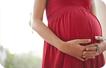 Pregnant woman wearing maternity dress made of elastic and stretchable fabric