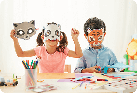 Two children wearing animal masks and expressing joy while role playing their animal characters