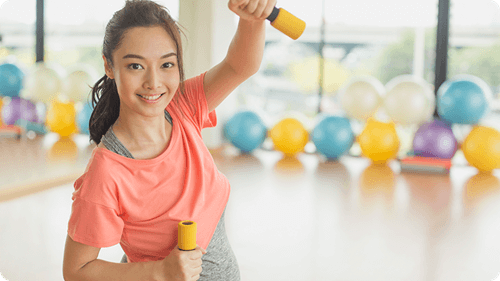 Pregnant woman working out with dumbbell 