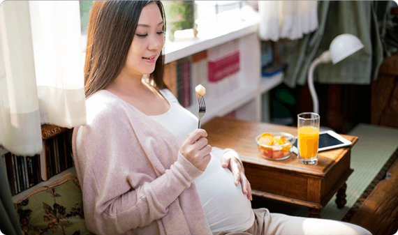 Young soon-to-be mum eating well during pregnancy