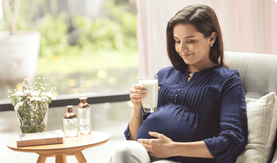 A mother holding a cup of pregnancy milk