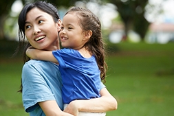 Mother is hugging a kid during patenring activities