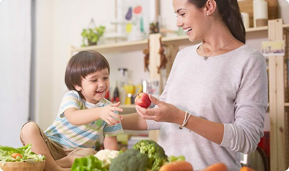 Mummy sharing apple with kid to ensure his health for grow