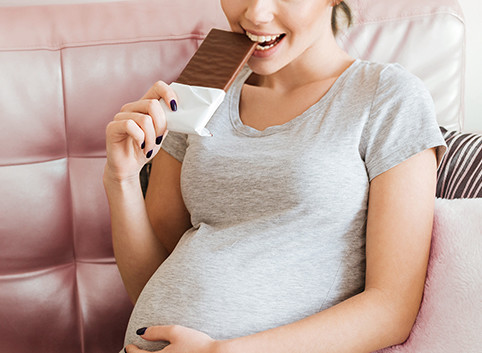 Pregnant woman eating chocolate moderately benefits