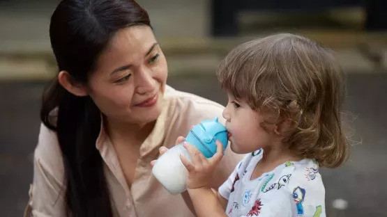 A child is drinking formula milk 