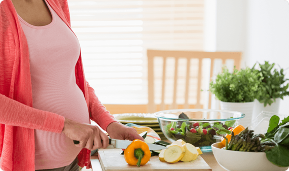 Pregnant woman preparing nutrition-based meal
