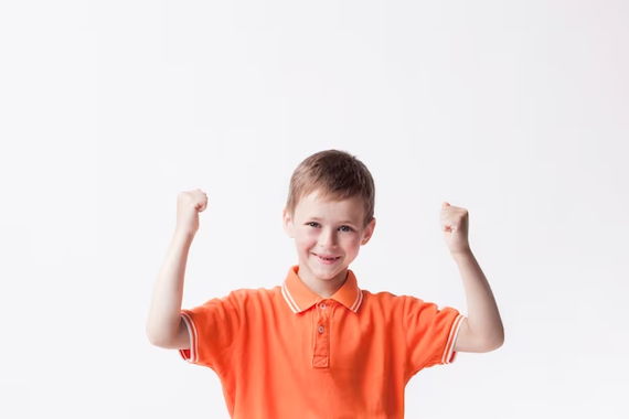 Young boy with arms raised
