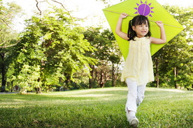 Girl holding a kite outdoor