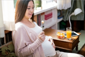 Young soon-to-be mum eating well during pregnancy