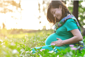 Pregnant woman enjoying her me time outdoor surrounded by greenery
