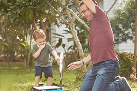 Family activity of a father and his son catching a fish 