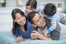 Parents playing with two children