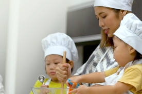 A mother baking with 2 children