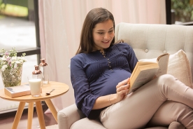 A pregnant woman reading a book