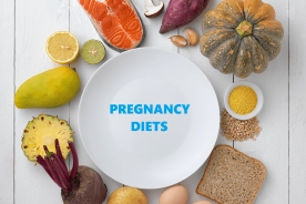 Plate surrounded by healthy food for pregnancy diet