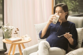 Pregnant mom drinking maternal milk after stir well