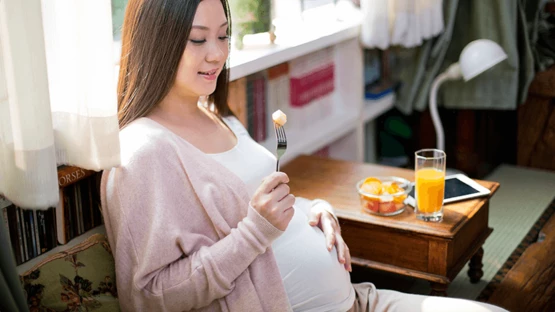 Young soon-to-be mum eating well during pregnancy