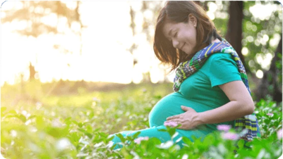 Pregnant woman enjoying her me time outdoor surrounded by greenery