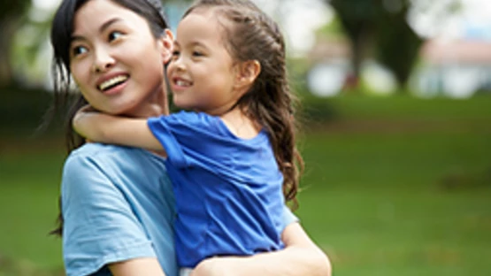 Mother is hugging a kid during patenring activities