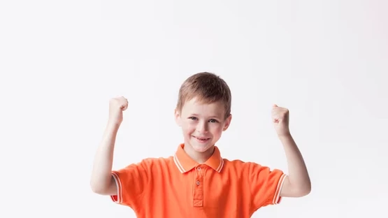 Young boy with arms raised