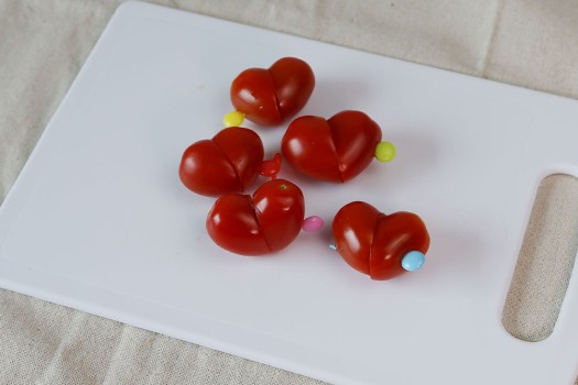 Heart shaped cherry tomatoes held together with toothpicks