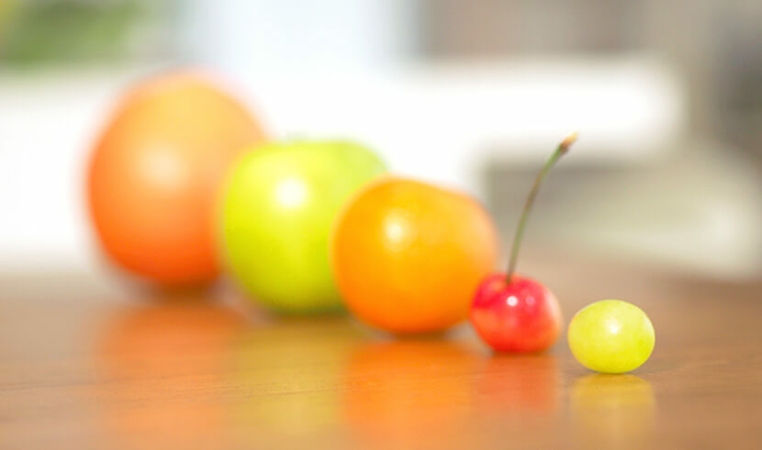 Various sizes of fruits displaying on table